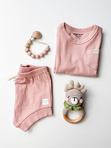 Organic baby girl gift box with cotton outfit, dummy chain, and crochet toy