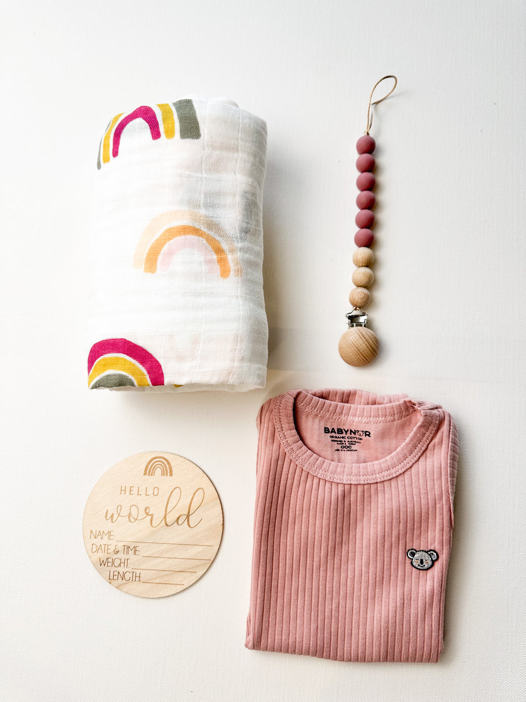 Eco-friendly newborn gift set for girls with rainbow muslin and wooden sign