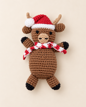 Load image into Gallery viewer, Crochet Christmas reindeer rattle wearing a red Santa hat and scarf
