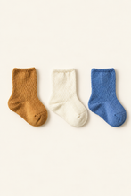 Load image into Gallery viewer, Babynor ribbed organic baby socks in ochre, cream and blue on a warm ivory background
